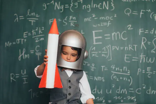 Photo of Young Business Boy with Space Helmet and Rocket