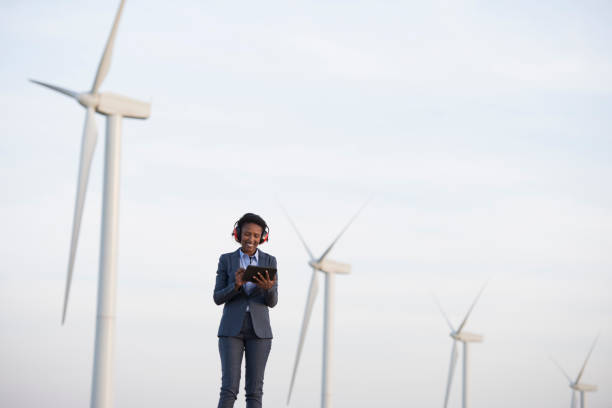 istock Renewable energy engineer woman at wind farm. 940361788