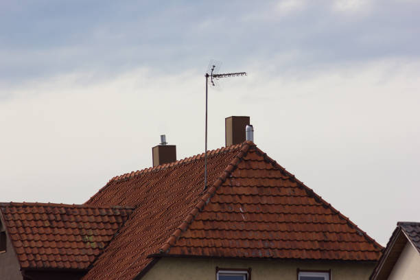 antenna on rooftop of a historical vintage building at easter springtime in south germany