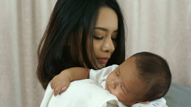 istock Young Beautiful Asia Mother caring and playing with her baby 940369680