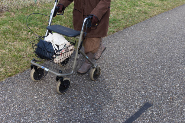 istock senior lady with rollator on a bikeway 940370078