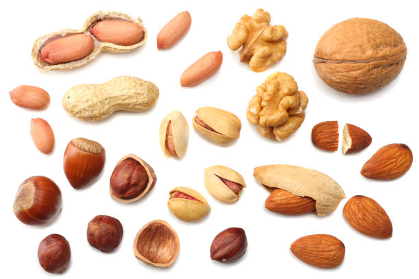 istock mix almonds, cashew nuts, hazelnut, peanuts, walnuts, pistachio isolated on white background. Top view 940381838