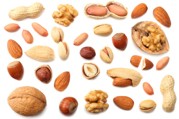 istock mix almonds, cashew nuts, hazelnut, peanuts, walnuts, pistachio isolated on white background. Top view 940381840