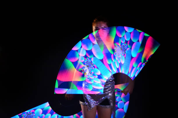istock Led poi. Laser show performance, dancer in led suits with LED lamp 940385648