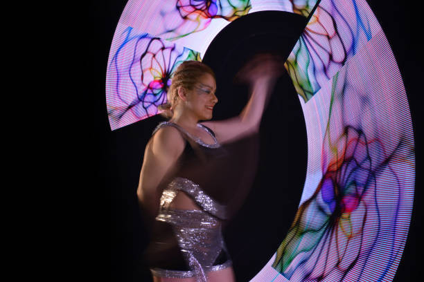 istock Led poi. Laser show performance, dancer in led suits with LED lamp 940386066