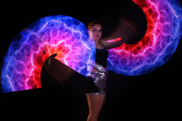 istock Led poi. Laser show performance, dancer in led suits with LED lamp 940387442