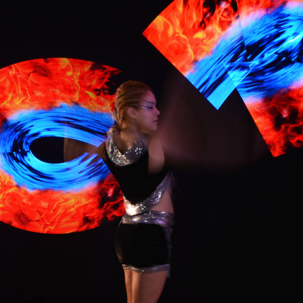 istock Led poi. Laser show performance, dancer in led suits with LED lamp 940390218