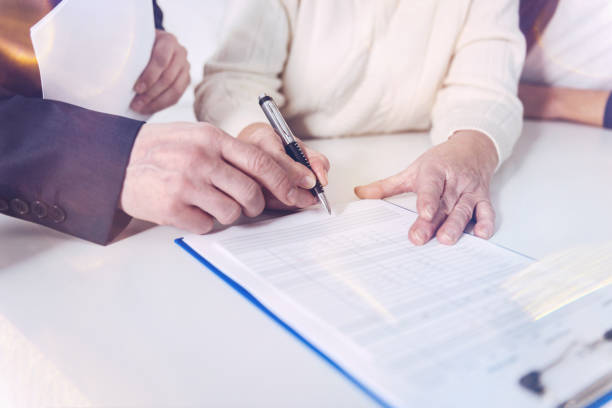 istock Aged pleasant woman signing insurance contract 940391018