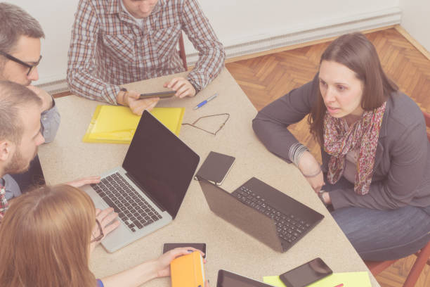 istock Real and ordinary young people in the office being creative and resolving business plans. 940391162