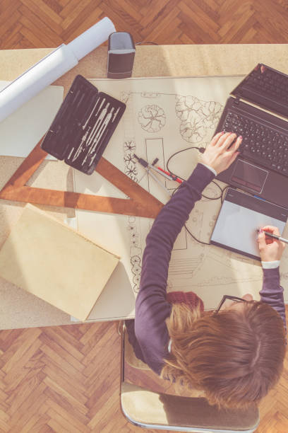 istock Female architect in a bright sunny room working on a project. 940391462