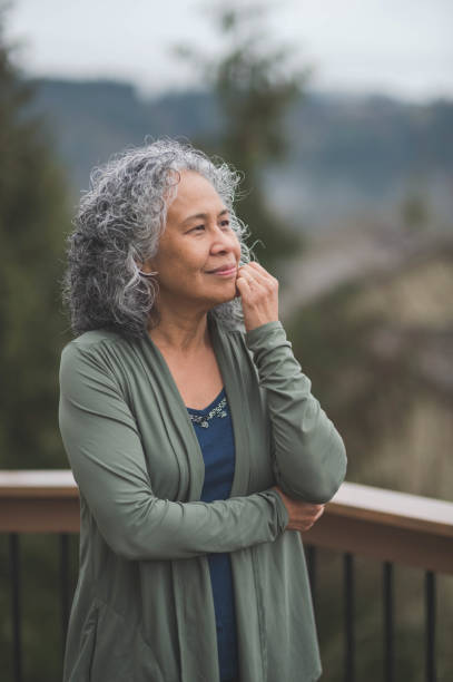 istock Senior ethnic woman practicing yoga outside on her back deck 940394078
