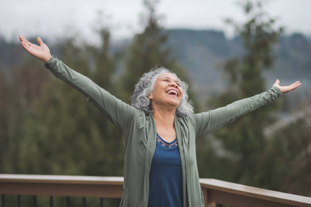istock Senior ethnic woman practicing yoga outside on her back deck 940394082