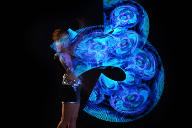 istock Led poi. Laser show performance, dancer in led suits with LED lamp 940394134