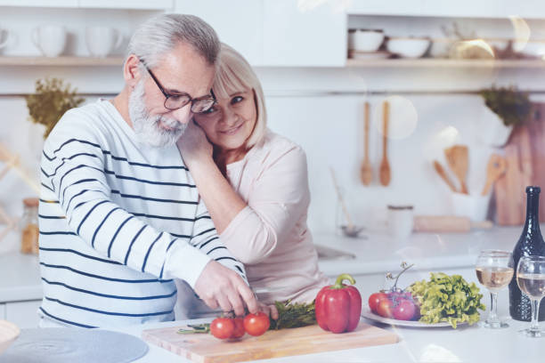 istock Positive lovign aged couple standing in the kitchen 940394316