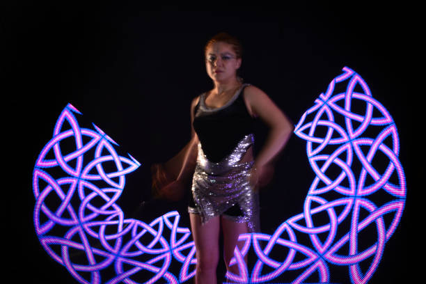 istock Led poi. Laser show performance, dancer in led suits with LED lamp 940396218