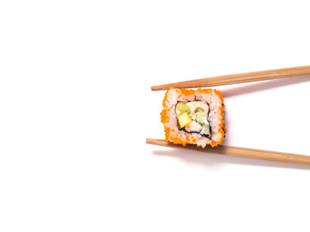 istock California roll and sticks on white background 940400812