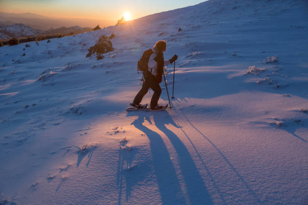 istock young woman enjoying snow on the mountain 940403254