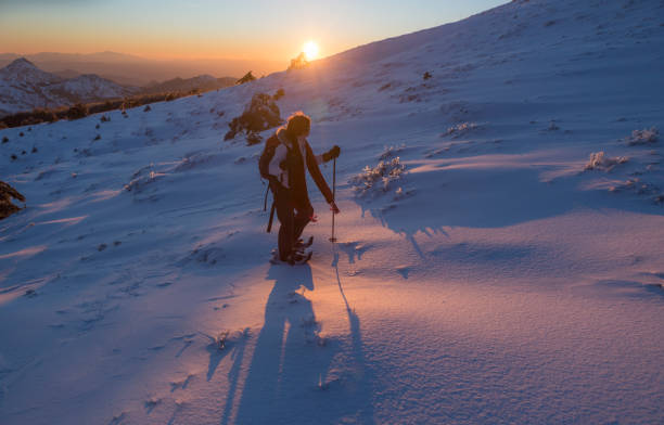 istock young woman enjoying snow on the mountain 940404082
