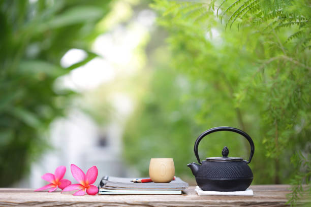 istock Black kettle and frangipani and notebooks at outdoor 940407376