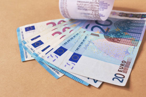 Grocery shopping list and money on a table