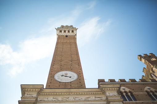 Mangia Tower with clock in Siena city