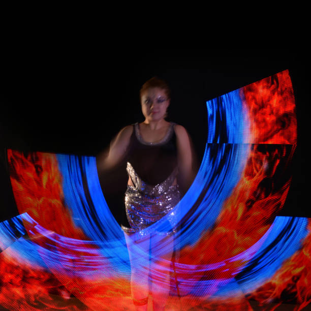 istock Led poi. Laser show performance, dancer in led suits with LED lamp 940413944