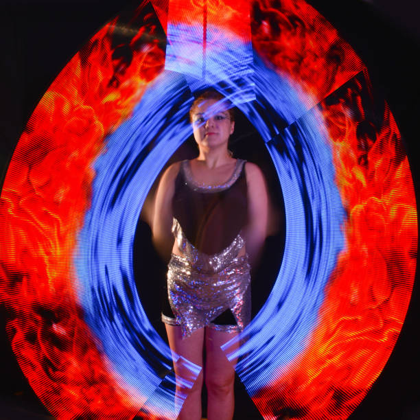istock Led poi. Laser show performance, dancer in led suits with LED lamp 940415334