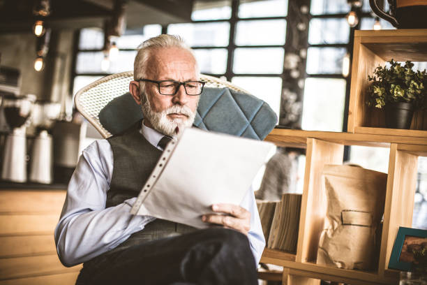 istock Senior businessman at his office checking a documents. 940415374