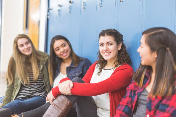 istock High school girls hanging out by lockers 940418140