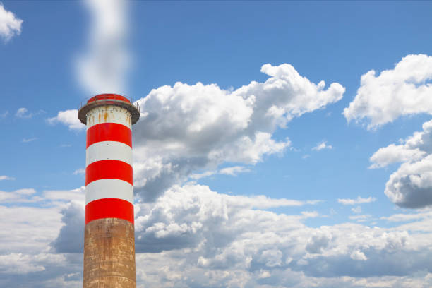 High concrete chimney emits CO2 into the atmosphere - concept image