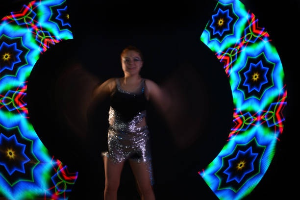 istock Led poi. Laser show performance, dancer in led suits with LED lamp 940418900