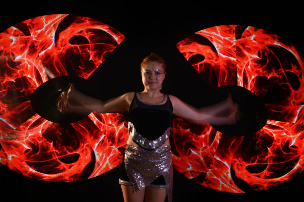 istock Led poi. Laser show performance, dancer in led suits with LED lamp 940432502