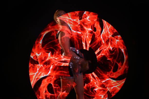 istock Led poi. Laser show performance, dancer in led suits with LED lamp 940433288