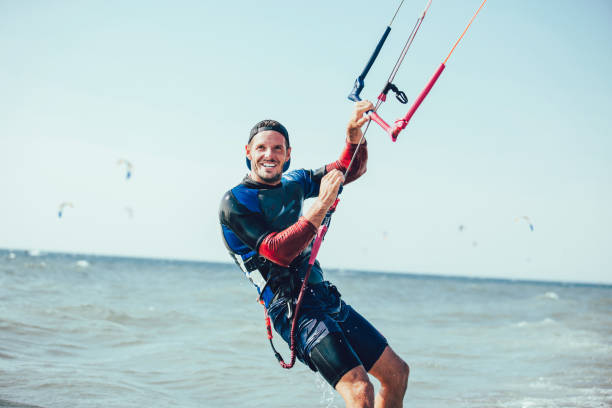 Athletic man riding on kite surf board