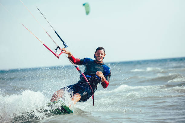 istock Athletic man riding on kite surf board 940433782