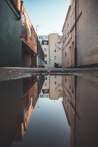 A street in London and its reflection in a puddle.