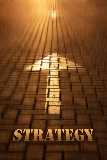 istock Strategy concept with arrow. Strategy word written on road at the sunset 940436200