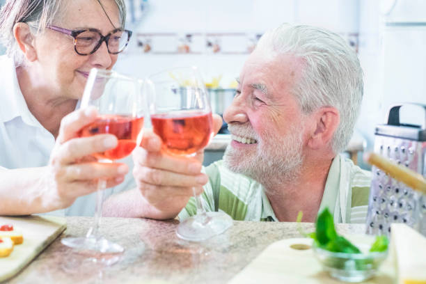 istock senior couple drinking wine at home 940436226
