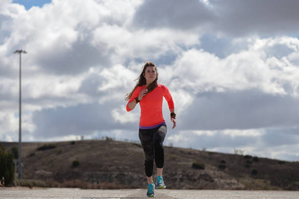 istock young woman running towards the camera 940437482
