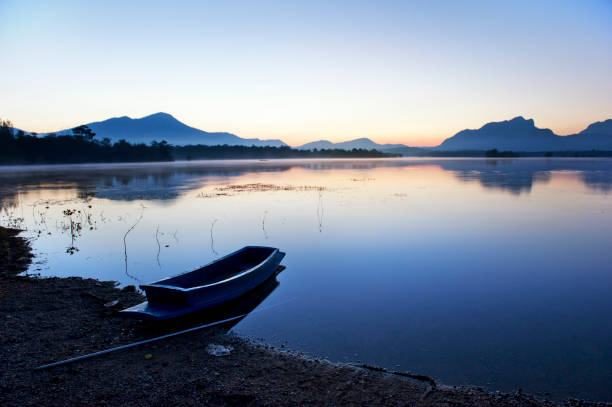 istock silence lake and boat in morning 940438134