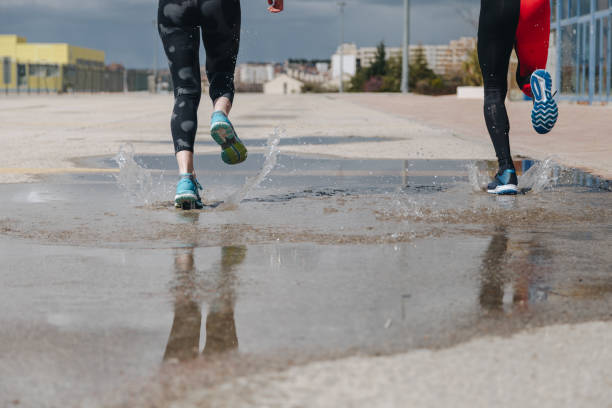 istock young adults couple running together 940438174