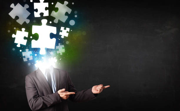 istock Character in suit with puzzle head concept 940438368