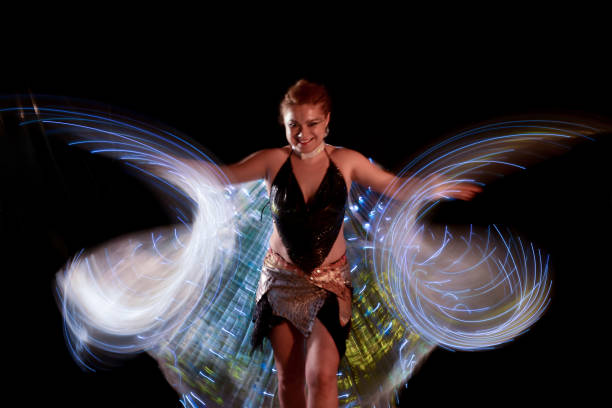istock Led poi. Laser show performance, dancer in led suits with LED lamp 940441284