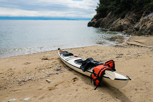 A sea kayak on a sandy beach