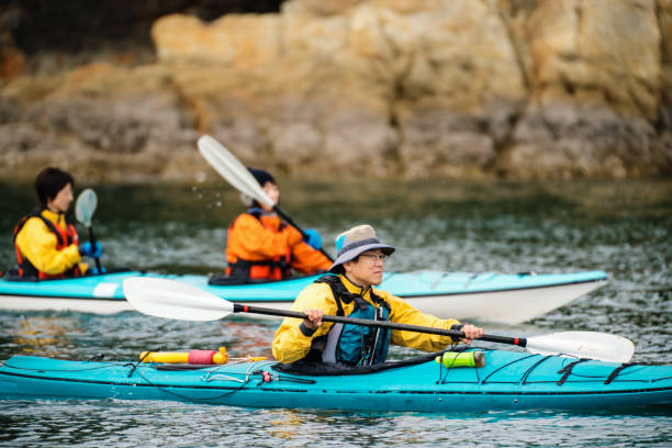 Some men and women sea kayaking together
