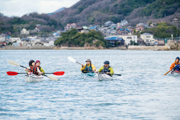 A group of men and women sea kayaking