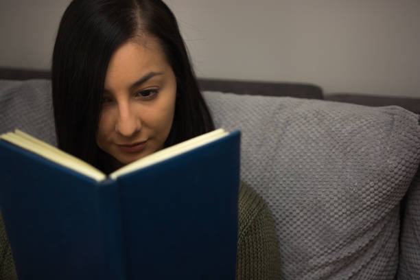 istock Pretty girl reading a book. 940442168