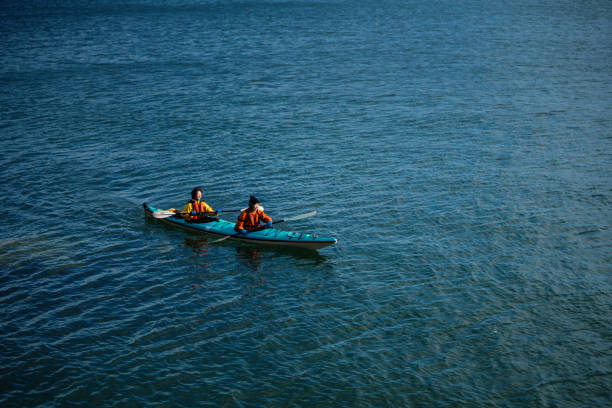 istock Two women in a sea kayak 940442388