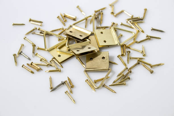 istock Gold tacks and hang up paintings in a white background 940446086