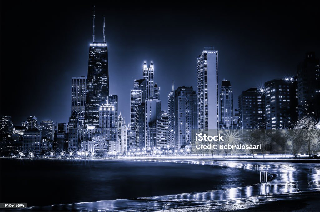 Glowing Chicago Skyline Blue tinted time lapse view along Chicago's curving lakeshore. Surreal view. Chicago - Illinois Stock Photo